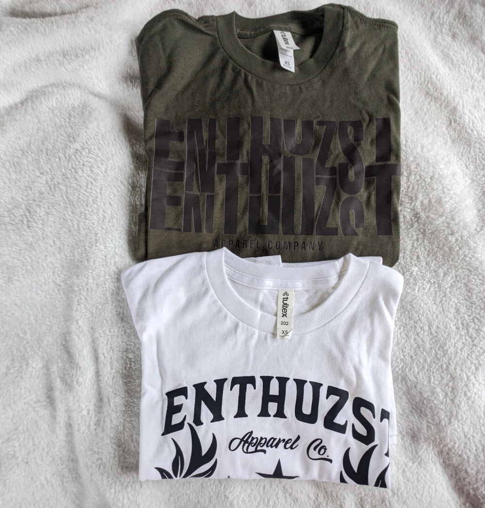 Enthuzst Graphic T-Shirts,  A Green T-shirt and A White T-shirt.